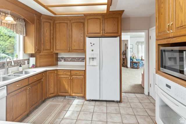 102 S 1000 W, Tremonton, UT 84337 - kitchen featuring white appliances, a sink, and brown cabinetry