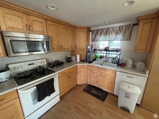 230 S 700 E, Orem, UT 84097 - kitchen with white appliances, a sink, light countertops, decorative backsplash, and light wood finished floors