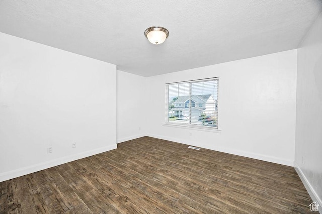 763 W 1060 S, Logan, UT 84321 - empty room featuring dark wood-style floors, baseboards, and a textured ceiling