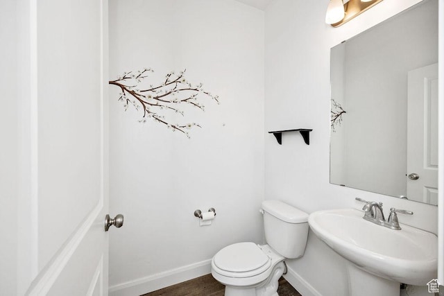 763 W 1060 S, Logan, UT 84321 - bathroom featuring baseboards, toilet, wood finished floors, and a sink