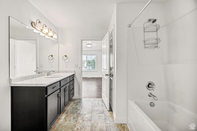 763 W 1060 S, Logan, UT 84321 - full bath featuring baseboards, bathing tub / shower combination, double vanity, and stone finish flooring
