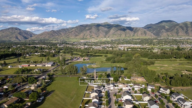 763 W 1060 S, Logan, UT 84321 - aerial overview of property's location with a water and mountain view, nearby suburban area, and a golf club