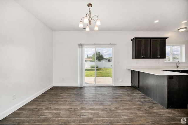 763 W 1060 S, Logan, UT 84321 - unfurnished dining area with healthy amount of natural light, a chandelier, dark wood-style floors, a sink, and recessed lighting