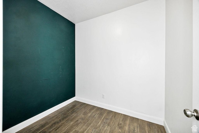 763 W 1060 S, Logan, UT 84321 - unfurnished room with dark wood-type flooring, baseboards, and vaulted ceiling