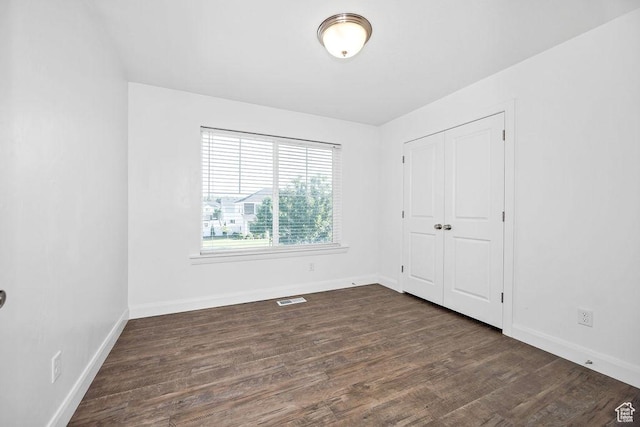 763 W 1060 S, Logan, UT 84321 - unfurnished bedroom with dark wood-type flooring, baseboards, and a closet