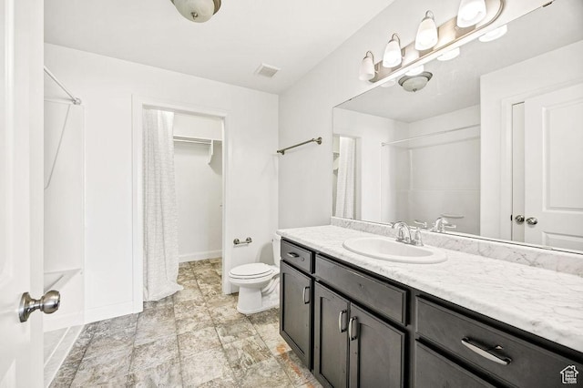 763 W 1060 S, Logan, UT 84321 - bathroom featuring vanity, a shower with shower curtain, baseboards, and toilet