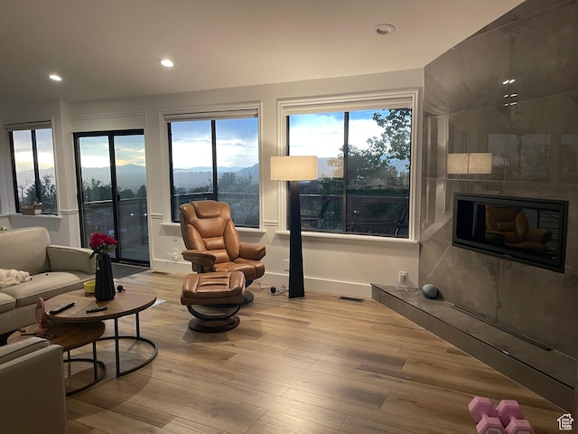 3599 E Oakview Dr, Millcreek, UT 84124 - living area with wood finished floors, recessed lighting, plenty of natural light, and a tile fireplace
