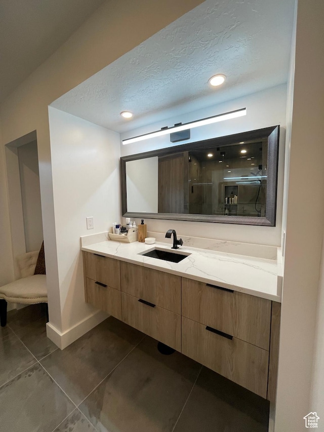 3599 E Oakview Dr, Millcreek, UT 84124 - bathroom featuring double vanity, a stall shower, recessed lighting, a textured ceiling, and tile patterned floors