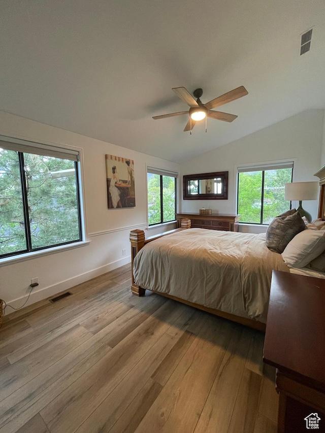 3599 E Oakview Dr, Millcreek, UT 84124 - bedroom featuring light wood-type flooring, vaulted ceiling, multiple windows, and a ceiling fan