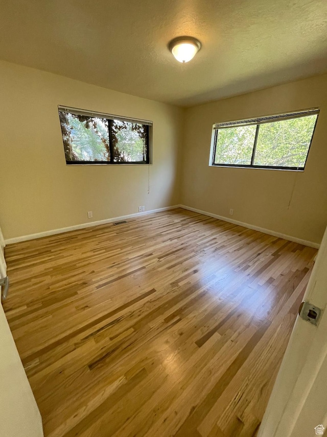 3599 E Oakview Dr, Millcreek, UT 84124 - unfurnished room with light wood finished floors and a textured ceiling