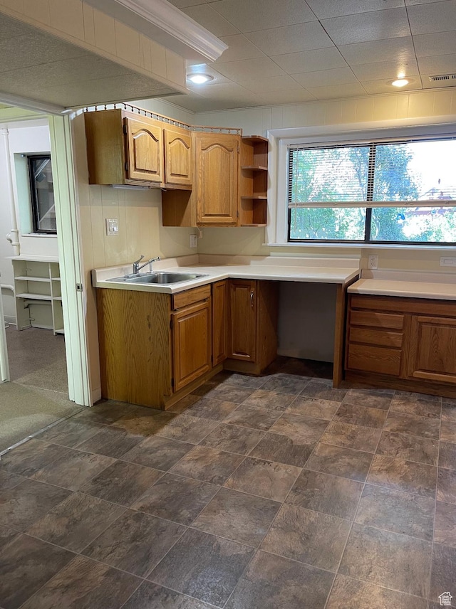 3599 E Oakview Dr, Millcreek, UT 84124 - kitchen with light countertops, brown cabinets, built in desk, and open shelves