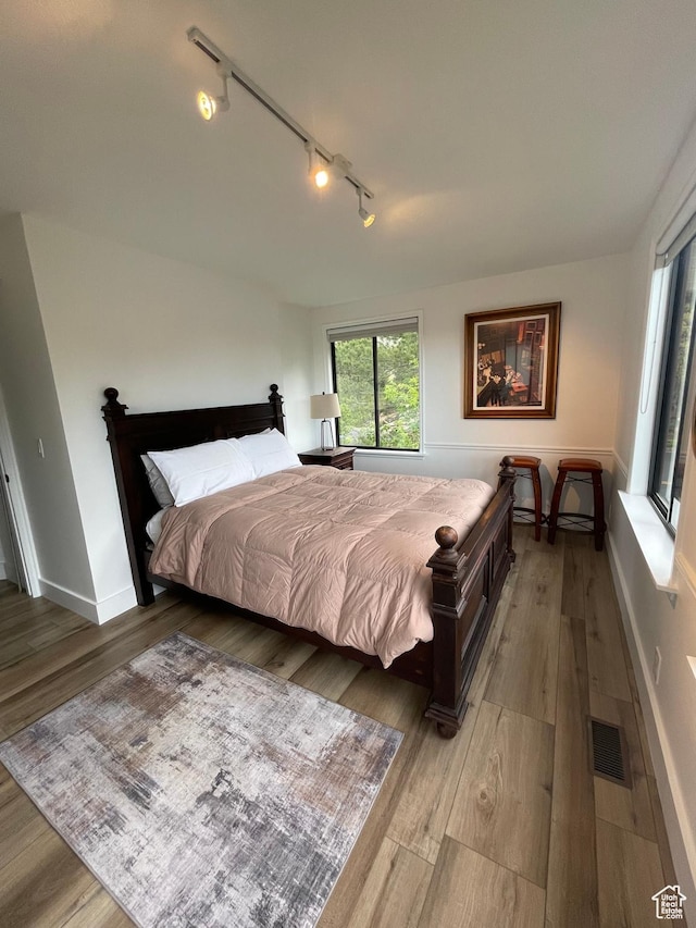 3599 E Oakview Dr, Millcreek, UT 84124 - bedroom with rail lighting and wood finished floors