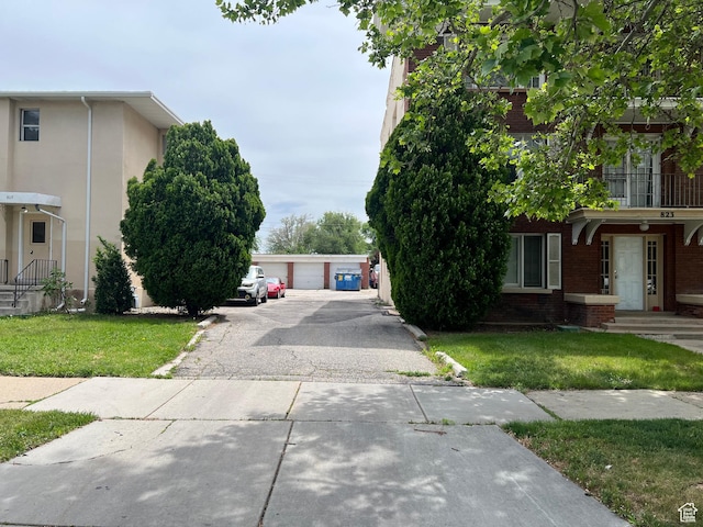 827 E 23rd St S, Ogden, UT 84401 - view of front facade with brick siding, a front yard, a garage, and an outbuilding