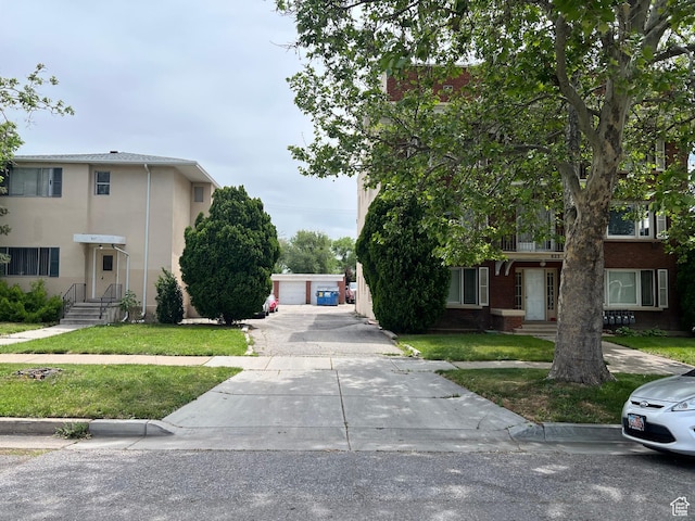 827 E 23rd St S, Ogden, UT 84401 - view of front of home with a front lawn, a detached garage, and stucco siding