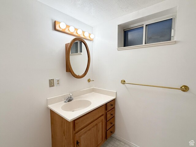 1066 Beecher Ave, Brigham City, UT 84302 - bathroom with vanity and a textured ceiling