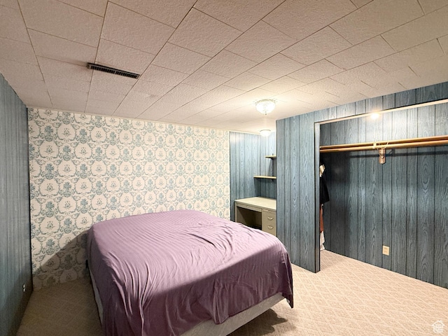 1066 Beecher Ave, Brigham City, UT 84302 - bedroom with wallpapered walls, carpet floors, a closet, and wood walls