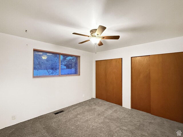 1066 Beecher Ave, Brigham City, UT 84302 - unfurnished bedroom with carpet, two closets, and ceiling fan