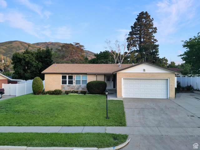1066 Beecher Ave, Brigham City, UT 84302 - single story home with a garage, concrete driveway, a mountain view, and brick siding