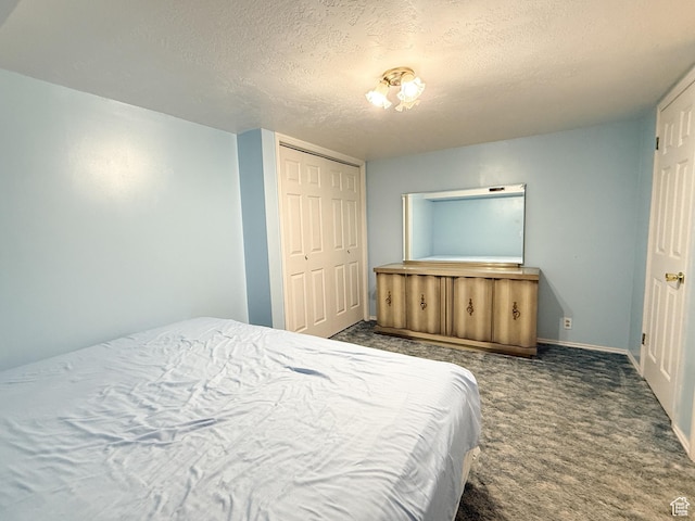 1066 Beecher Ave, Brigham City, UT 84302 - bedroom with a textured ceiling, carpet floors, baseboards, and a closet