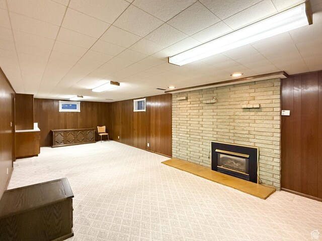 1066 Beecher Ave, Brigham City, UT 84302 - finished below grade area with carpet flooring, wood walls, and a fireplace