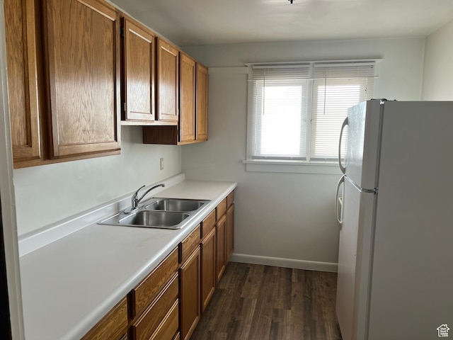 823 E 23rd St S, Ogden, UT 84401 - kitchen with freestanding refrigerator, a sink, dark wood finished floors, light countertops, and brown cabinets
