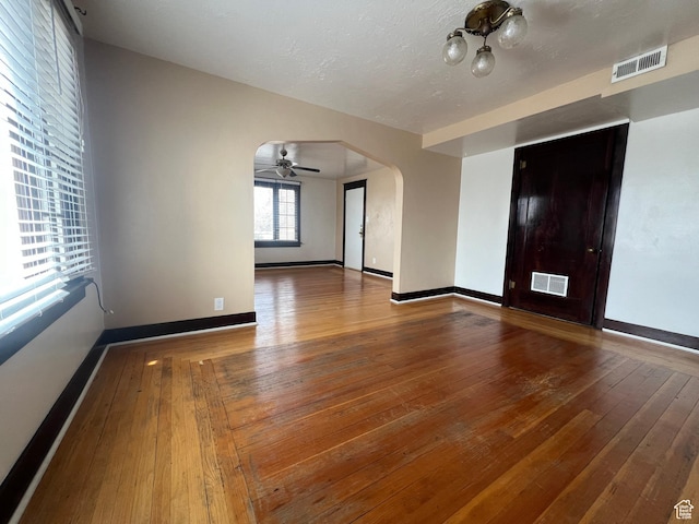 823 E 23rd St S, Ogden, UT 84401 - empty room featuring arched walkways, hardwood / wood-style floors, baseboards, and a ceiling fan