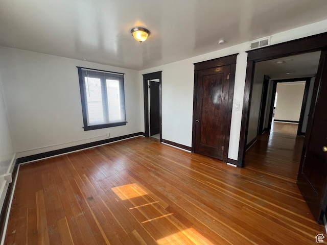 823 E 23rd St S, Ogden, UT 84401 - unfurnished bedroom featuring wood-type flooring, two closets, and baseboards