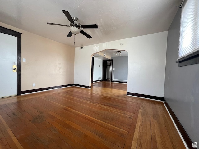 823 E 23rd St S, Ogden, UT 84401 - spare room featuring arched walkways, ceiling fan, hardwood / wood-style flooring, and baseboards