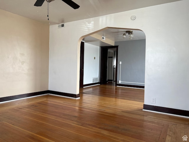 823 E 23rd St S, Ogden, UT 84401 - empty room featuring arched walkways, ceiling fan, hardwood / wood-style flooring, and baseboards