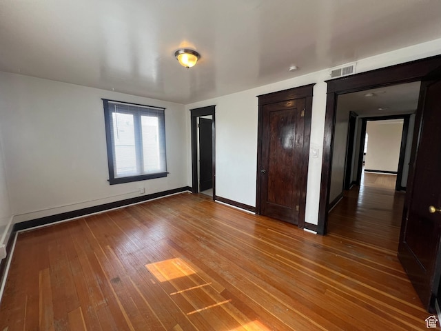 823 E 23rd St S, Ogden, UT 84401 - unfurnished bedroom with hardwood / wood-style floors, two closets, and baseboards