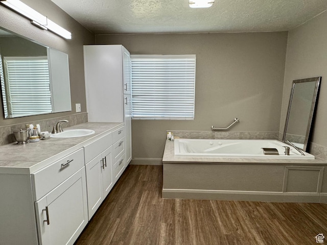 160 W 100 S, Fillmore, UT 84631 - bathroom featuring wood finished floors, vanity, a bath, and a textured ceiling