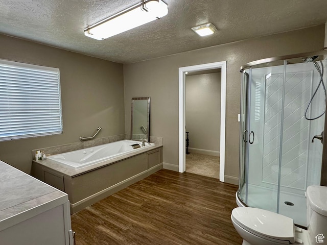 160 W 100 S, Fillmore, UT 84631 - bathroom featuring wood finished floors, a textured ceiling, a stall shower, a garden tub, and toilet