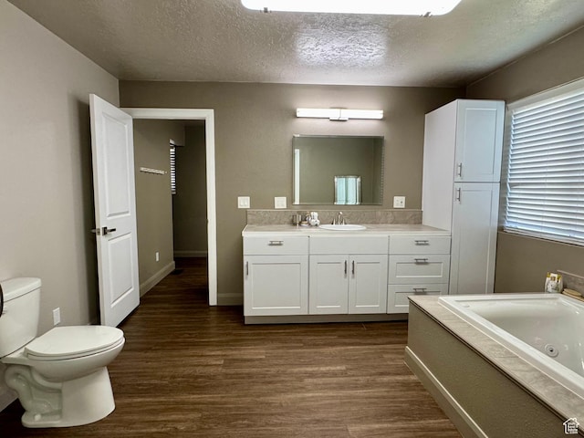160 W 100 S, Fillmore, UT 84631 - bathroom with wood finished floors, vanity, a whirlpool tub, toilet, and a textured ceiling