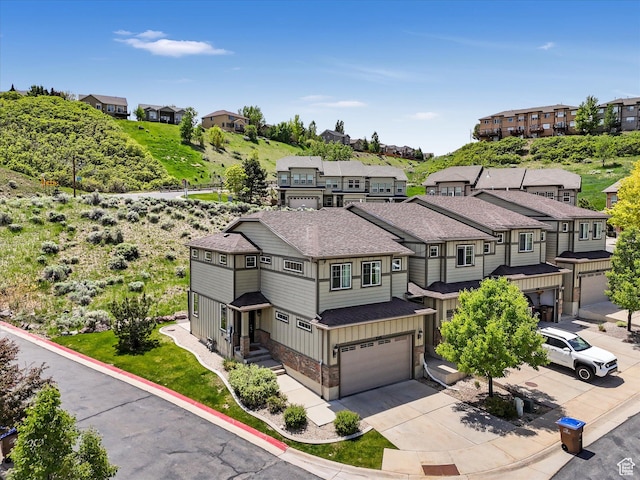 2286 E Deer Park Ln, Draper, UT 84020 - view of front of property featuring roof with shingles, an attached garage, stone siding, concrete driveway, and a residential view