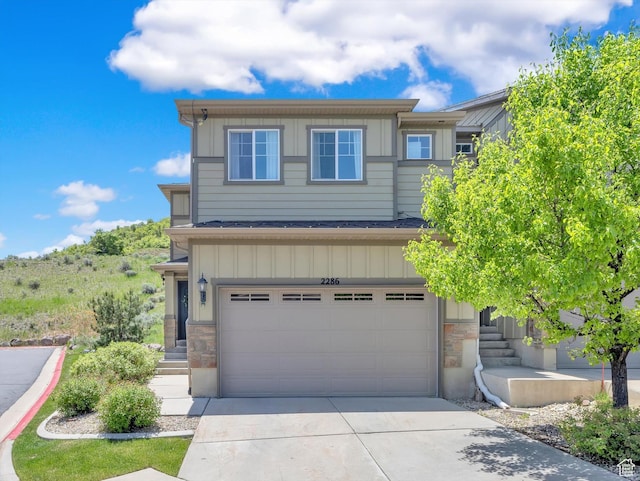 2286 E Deer Park Ln, Draper, UT 84020 - view of front of property with board and batten siding, an attached garage, stone siding, and driveway