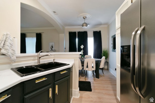 1559 W Alsace Way, West Valley City, UT 84119 - kitchen featuring stainless steel refrigerator with ice dispenser, a sink, crown molding, light countertops, and light wood-style floors