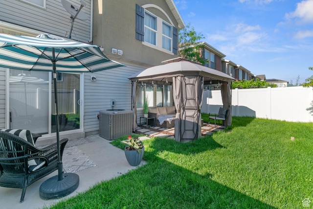 1559 W Alsace Way, West Valley City, UT 84119 - rear view of property featuring a gazebo, a patio area, an outdoor hangout area, and central AC unit