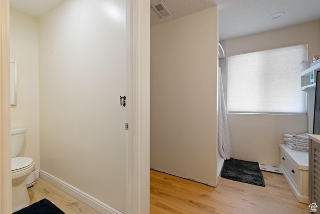 1559 W Alsace Way, West Valley City, UT 84119 - bathroom featuring wood finished floors, toilet, and vanity