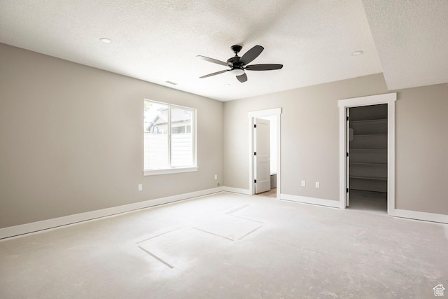 1928 E 540 S, Heber City, UT 84032 - unfurnished bedroom with a spacious closet, a textured ceiling, a ceiling fan, concrete floors, and a closet