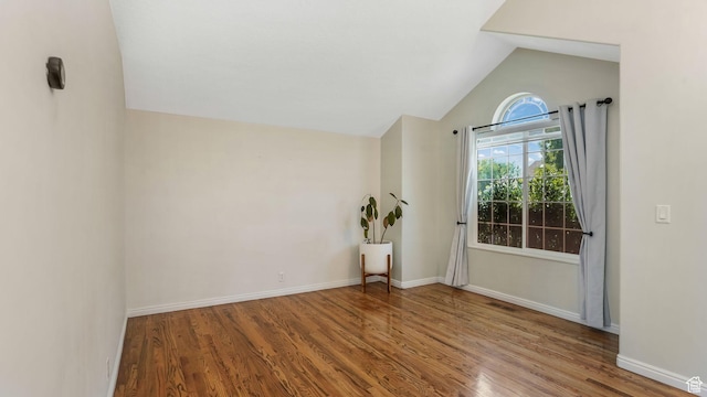 9677 S Iron Gate Rd, South Jordan, UT 84095 - unfurnished room with wood finished floors, vaulted ceiling, and baseboards