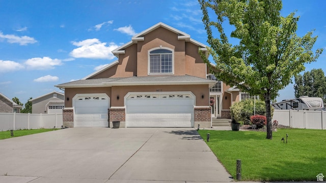 9677 S Iron Gate Rd, South Jordan, UT 84095 - view of front of house featuring brick siding, concrete driveway, stucco siding, and an attached garage