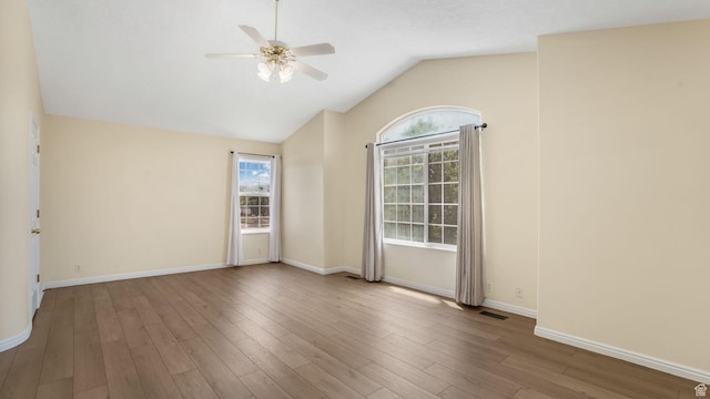 9677 S Iron Gate Rd, South Jordan, UT 84095 - spare room with ceiling fan, vaulted ceiling, wood finished floors, and baseboards