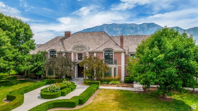 4234 N Vintage Cir, Provo, UT 84604 - french country inspired facade with a chimney, a front lawn, brick siding, and a mountain view