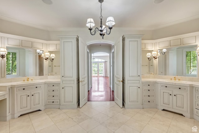 4234 N Vintage Cir, Provo, UT 84604 - bathroom with a chandelier, two vanities, tile patterned flooring, and crown molding