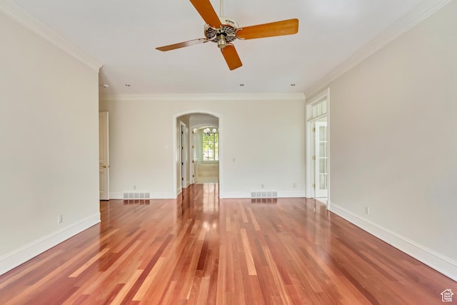 4234 N Vintage Cir, Provo, UT 84604 - spare room with arched walkways, ornamental molding, a ceiling fan, light wood-style flooring, and baseboards