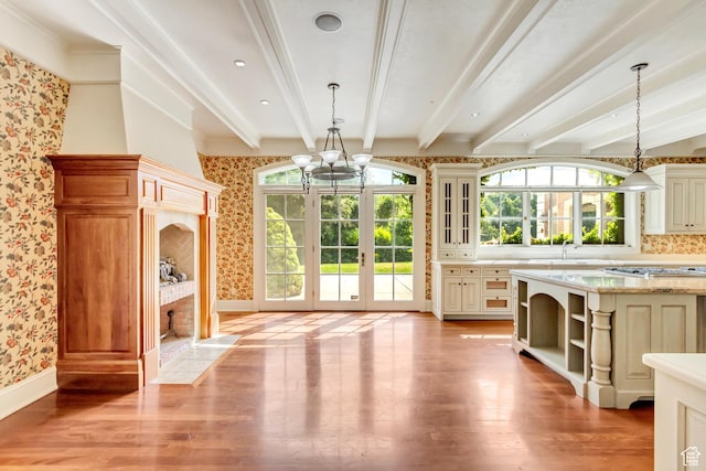 4234 N Vintage Cir, Provo, UT 84604 - unfurnished dining area featuring wallpapered walls, healthy amount of natural light, a fireplace with flush hearth, beam ceiling, and light wood-style floors