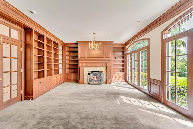 4234 N Vintage Cir, Provo, UT 84604 - unfurnished living room with built in features, a chandelier, carpet, crown molding, and a fireplace