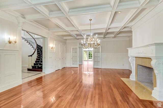 4234 N Vintage Cir, Provo, UT 84604 - unfurnished living room with a chandelier, light wood finished floors, stairway, a decorative wall, and a fireplace