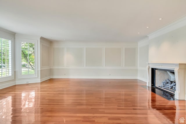 4234 N Vintage Cir, Provo, UT 84604 - unfurnished living room featuring light wood finished floors, crown molding, a fireplace with flush hearth, and baseboards