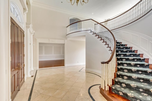 4234 N Vintage Cir, Provo, UT 84604 - entrance foyer featuring inlaid floor details, a high ceiling, stairs, ornamental molding, and baseboards